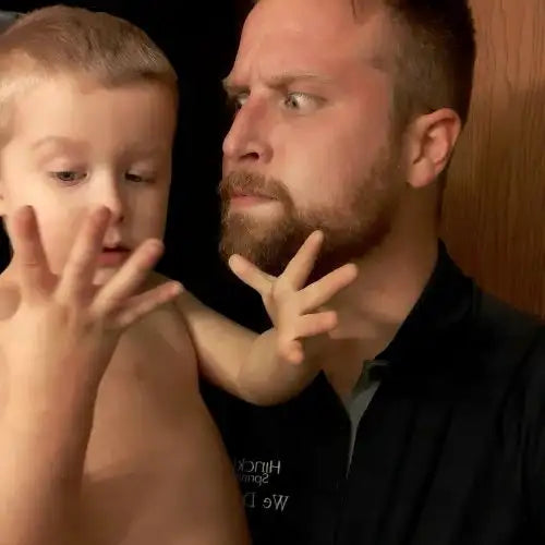 Un homme barbu portant une chemise noire.